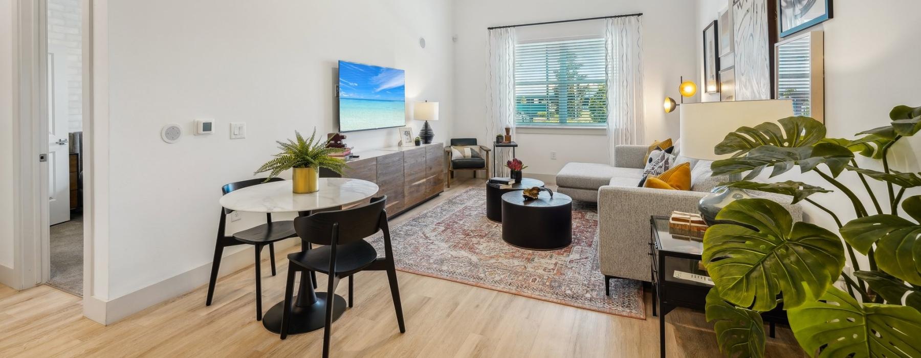 a living room with a table and chairs